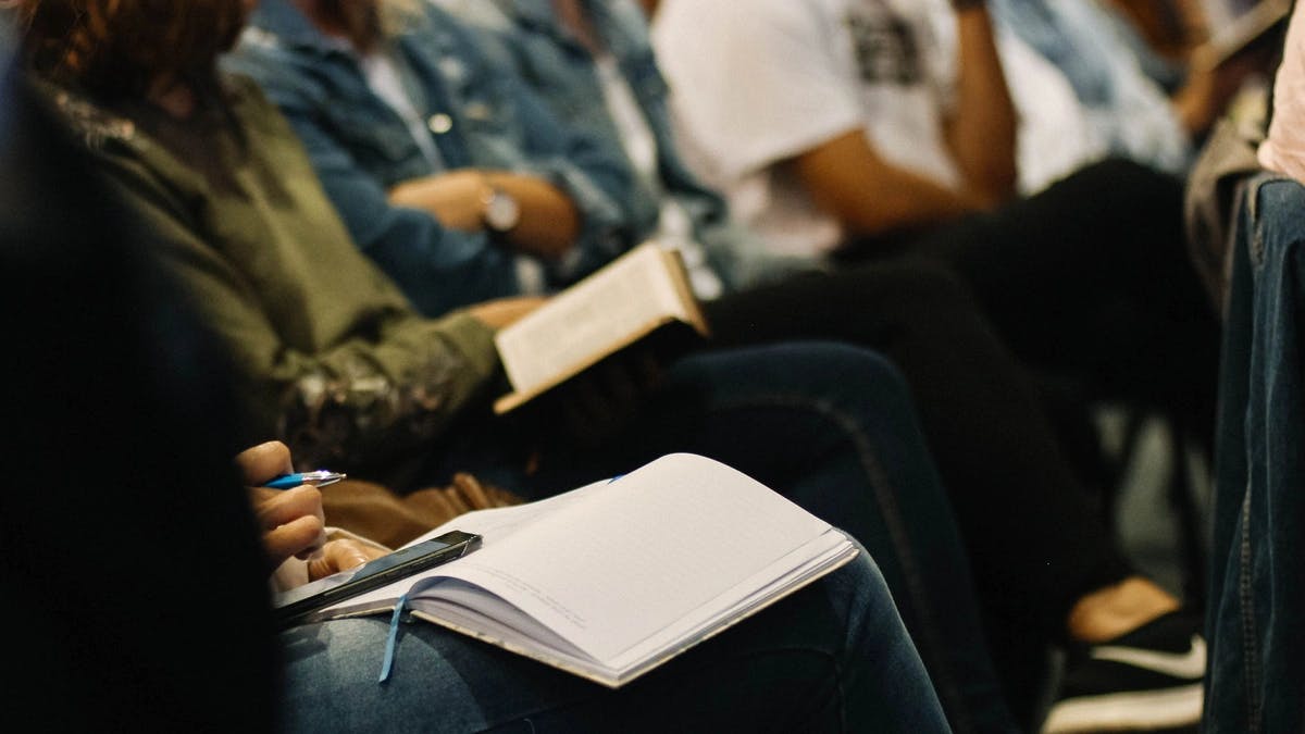 close up of people with journals and bibles