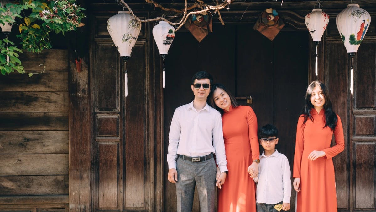 family of four holding hands